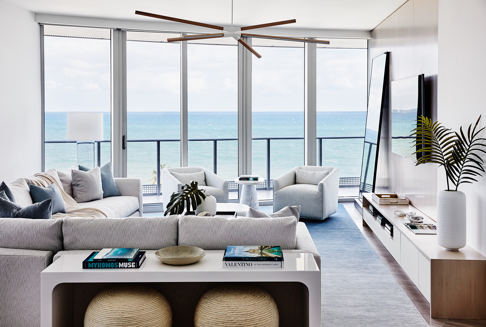 Bright and modern living room with ocean views by South Florida Interior Design Firm Workshop/APD